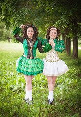 Two young beautiful girl in irish dance dress posing outdoor © darkbird