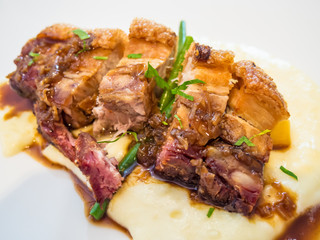 Crispy Pork Belly served with mash potatoes and scallion