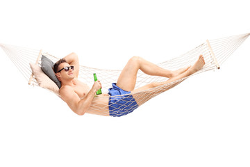 Handsome young man lying in a hammock