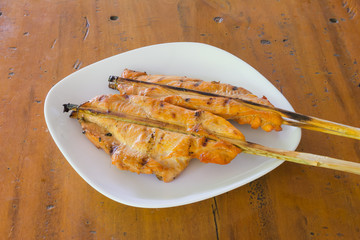 grilled chicken  on white dish,wood background