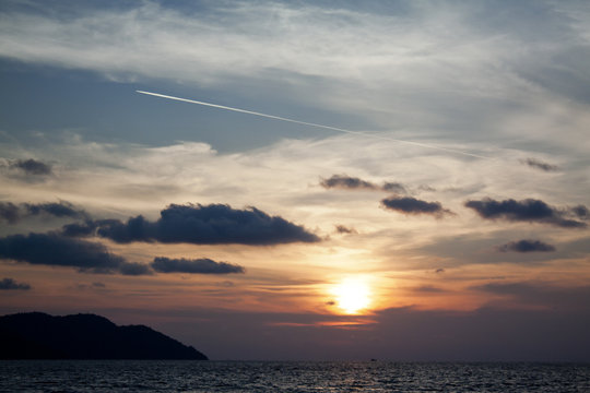 Airplane Contrail Against Sunset Sky