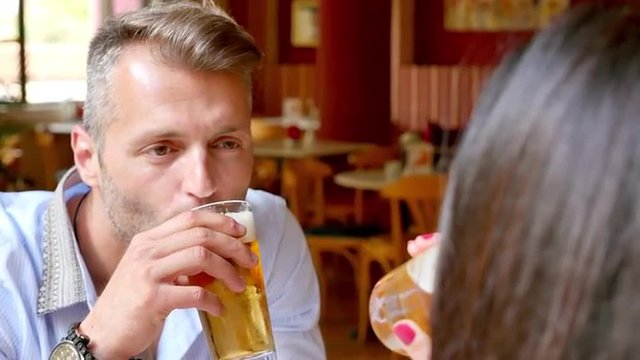 Handsome Greek man talking on a date at a cafe in Greece