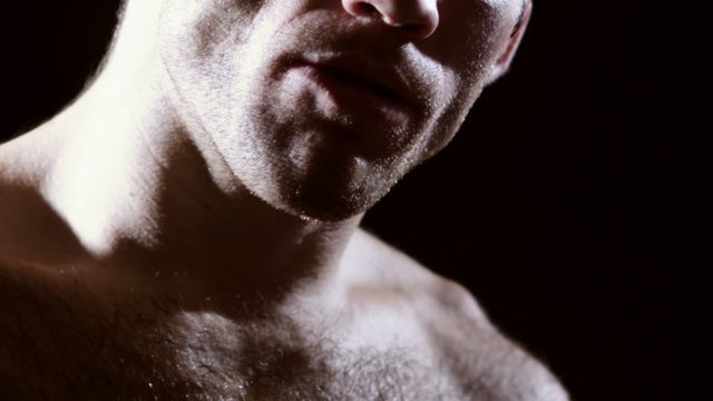 Mixed martial arts athlete removes his mouth protection. Close up shot.