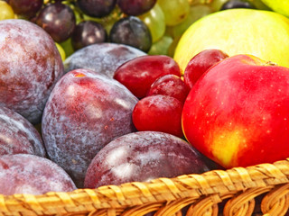 Ripe fruits on a straw pot.