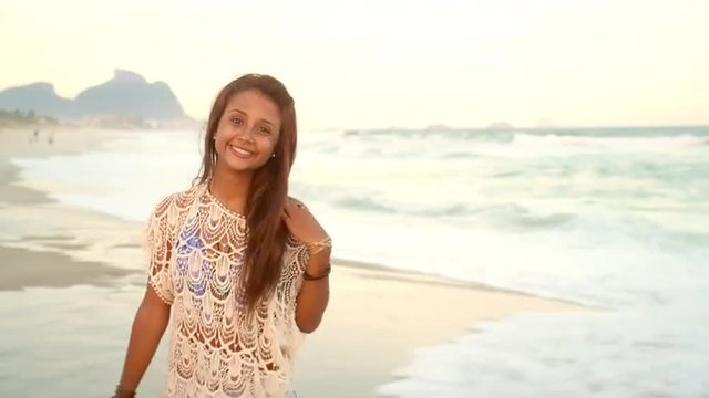 Beautiful young Brazilian woman smiles on a beach in Brazil