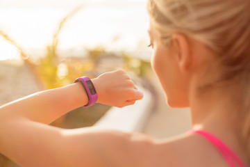 Woman looking at wearable fitness device