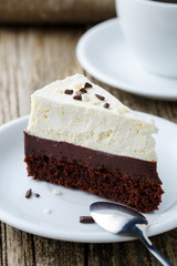 Vanilla cheesecake slice on wooden background.