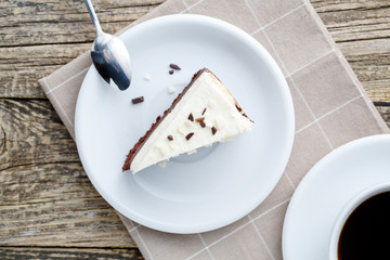 Vanilla cheesecake slice on wooden background.