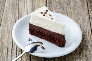 Vanilla cheesecake slice on wooden background.