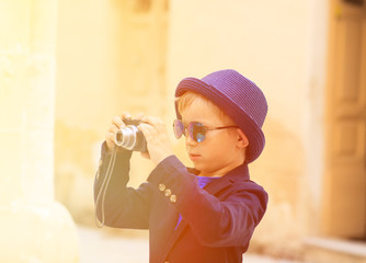 little boy taking photos while travel in Europe