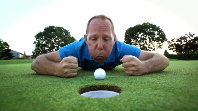 Close up shot of golfer yelling at his ball to go into the hole