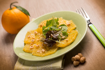 orange carpaccio salad with hazelnut, selective focus