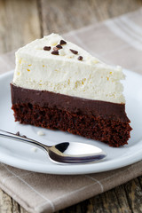 Vanilla cheesecake slice on wooden background.