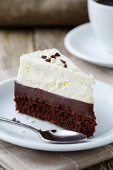 Vanilla cheesecake slice on wooden background.