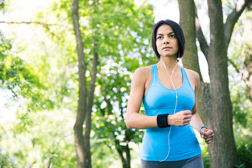 Fototapeta premium Sporty young woman running outdoors
