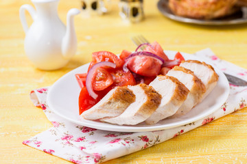 Grilled chicken breasts with fresh tomato salad