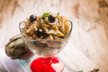 pasta with artichoke and black olives, selective focus