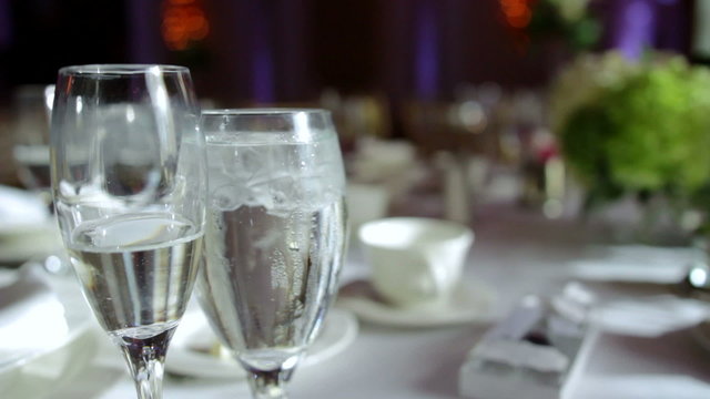 Champagne and water glass on a set banquet table.