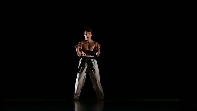Man training taekwondo or karate Isolated on Black background