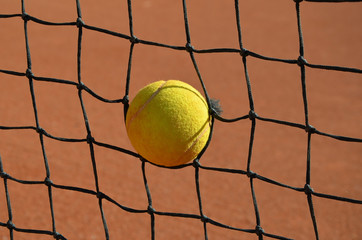 tennis ball in the tennis net photo