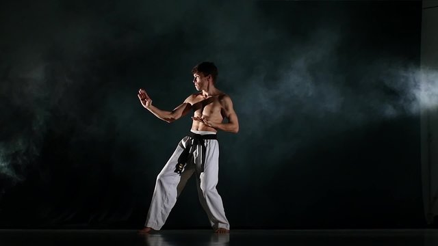 Man training taekwondo or karate Isolated on Black background