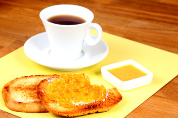 served breakfast: cup of coffee, toasts and orange jam