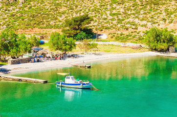 Amazing sea bay on Greek Island with fishing boat