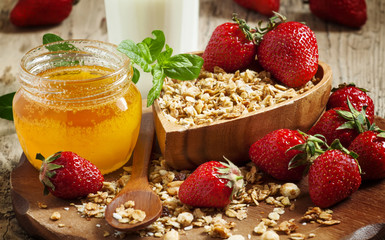 Healthy breakfast buffet with homemade muesli, honey, strawberri