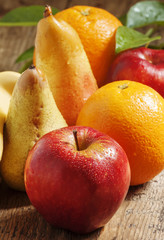 Colored fruits: apple, banana, orange, pear, selective focus
