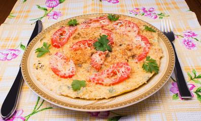 Omelet with cauliflower, tomatoes, fresh herbs and cheese