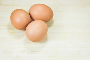 three eggs on wood background