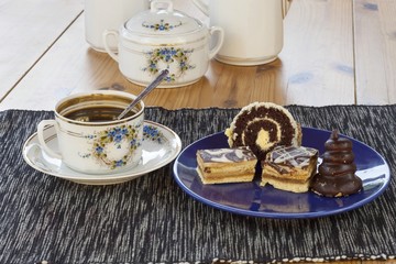 dessert with coffee, chocolate cakes and rolls