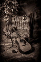 Acoustic Guitar and Empty Chair in Black and White