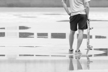 skateboarder standing and thinking about new trick