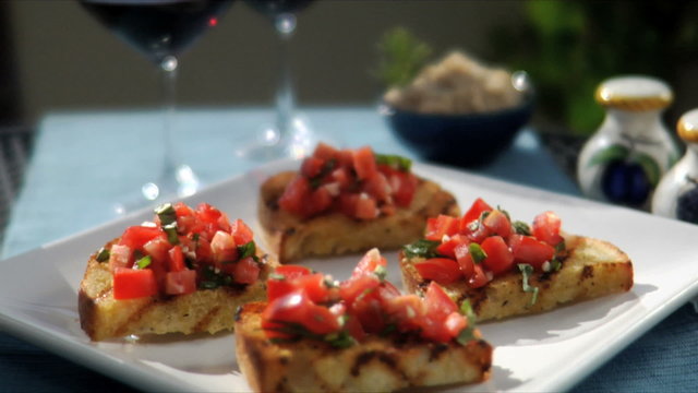 Classic Italian bruschetta tomato and onion on toasted bread sitting on a table