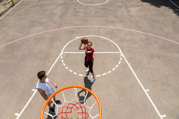 Fototapeta premium High Angle View of Couple Playing Basketball