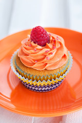 Delicious cream and raspberry cupcake