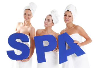 women holding spa letters