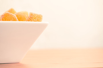 Candy ginger in white porcelain bowl