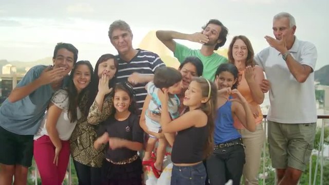 Family posing for a portrait at a Brazilian family BBQ