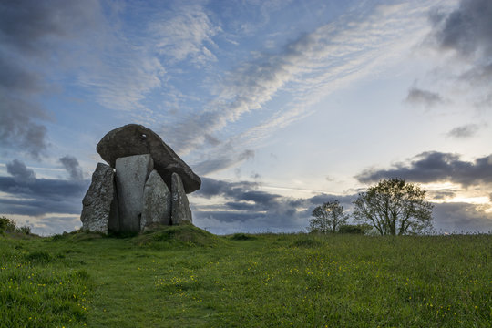 Trethevy Quoit, Cornwall, UK at sunset with blue sky and clouds