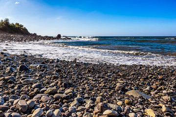 Wild stone beach on coast of ocean