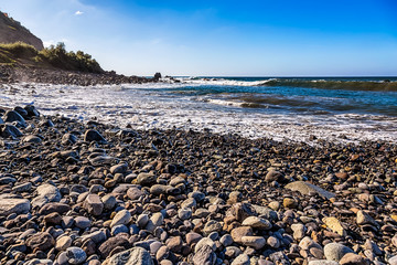 Fototapeta na wymiar Stone beach on coast of ocean