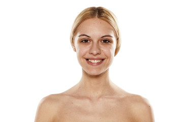 smiling young woman without makeup on a white background