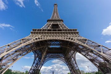 Obraz na płótnie Canvas The Eiffel Tower and Montparnasse tower over blue sky