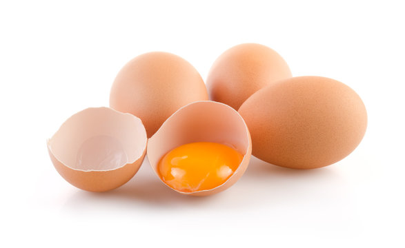 Brown Eggs with one broken on white background