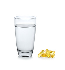 glass of water  with fish oil on white background