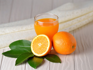 Glass of  orange juice  on white wooden background