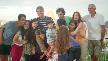 Family posing for a portrait at a Brazilian family BBQ - Powered by Adobe