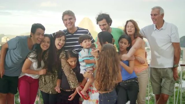 Family posing for a portrait at a Brazilian family BBQ